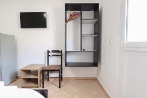 a dining room with a table and a chair at Vila Enea in Ksamil