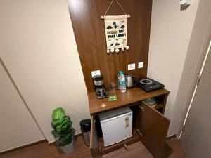 an office with a desk with a coffee maker on it at Luxury Swing Suite - Bliss Suites in Greater Noida