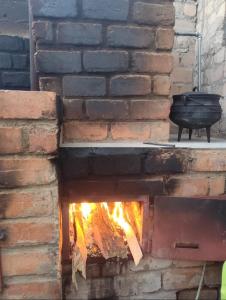 a brick oven with a fire in it at A Great Guest House Grootfontein in Groutfontein