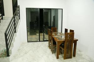 a dining room with a wooden table and chairs at Danu Homestay Kandy in Kandy