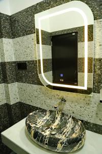a bathroom with a sink with a mirror at Danu Homestay Kandy in Kandy +39 photos