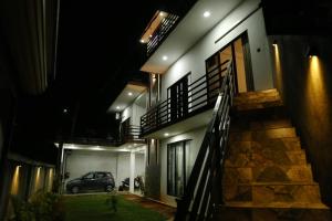 a car parked in front of a house at night at Danu Homestay Kandy in Kandy