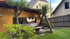 a wooden bench in a yard next to a building at penzion ŽEROTÍN in Staré Město