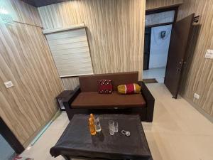 a living room with a couch and a table at new Subh Apartment in Bhowāli