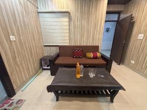 a living room with a couch and a table at new Subh Apartment in Bhowāli