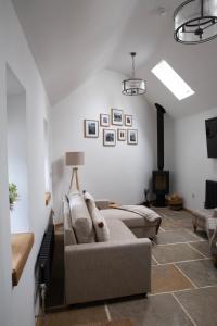 a living room with a couch and a fireplace at The Old Blacksmiths in Bridgnorth