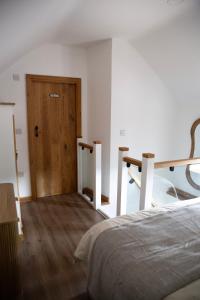 a bedroom with a bed and a wooden door at The Old Blacksmiths in Bridgnorth
