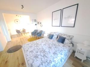 a bedroom with a bed and a living room at Apartman Karmen in Vodice