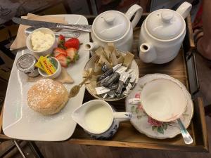 a table with a tea set with strawberries and food at The Bell Inn in Devizes +7 photos