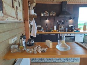 a kitchen with a wooden counter top in a room at Zeltarasa in Avotkalni