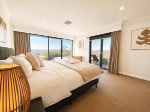 a bedroom with a large bed with a large window at Zig Zag Retreat - Hilltop Home With Stunning Views in Perth +66 photos