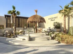 a courtyard with stairs and palm trees in front of a building at Inter Home Coral - beach access in Ras al Khaimah