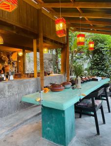a table with plates and bowls on top of it at Kandy Living Homestay in Kandy
