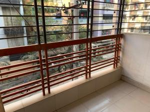 a room with a window with wooden blinds at Baral White Rose Hotel Dhaka in Dhaka