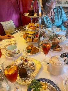 a woman sitting at a table with plates of food at The Bell Inn in Devizes