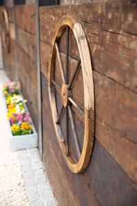 a wooden wall with a wooden wheel on it at The Old Blacksmiths in Bridgnorth