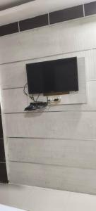 a television on a wall in a room at Hotel Neelkanth in Lucknow +5 photos