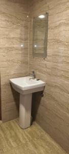 a bathroom with a sink and a mirror at Hotel Neelkanth in Lucknow