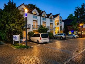 a van parked in a parking lot in front of a building at FlexInn Hotel Gelsenkirchen in Gelsenkirchen