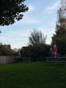 a park with benches and flags in the grass at The Bell Inn in Devizes