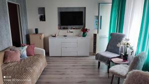 a living room with a sink and a couch at Liepaja Beach in Liepāja