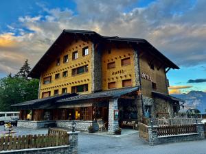 a large wooden building with a mountain at Colorado Riders Chalet in Crans-Montana