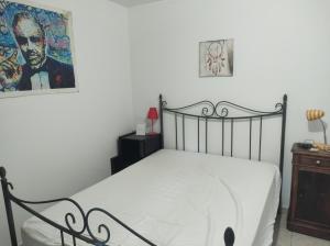 a bedroom with a bed and a picture on the wall at Fab's Home in Oust