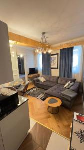 a living room with a couch and a table at My Mountain View - 50 m od Krupówek in Zakopane