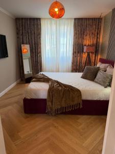 a bedroom with a bed with a blanket on it at GZP Residence Lugoj 13 in Lugoj