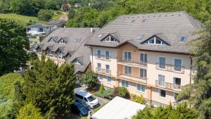 an apartment building with a van parked in front of it at Hotel Empire Europe in Prievidza
