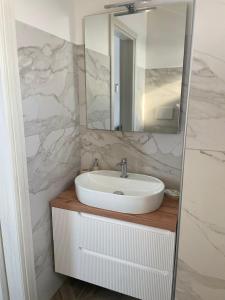 a bathroom with a white sink and a mirror at Essenza di Mare Luxury B&B in Torre dell'Orso +17 photos