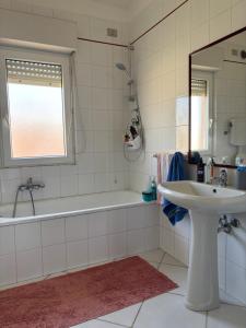 a bathroom with a tub and a sink and a bath tub at Comfort Home in Capoterra