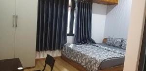 a bedroom with a bed and a window with curtains at COMIC 2 Homestay in Danang