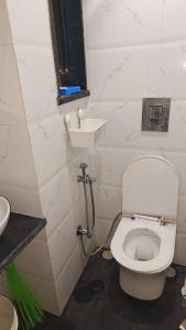 a bathroom with a toilet and a sink at Meenaji's home in Mumbai