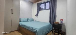 a small bedroom with a bed and a window at COMIC 2 Homestay in Danang