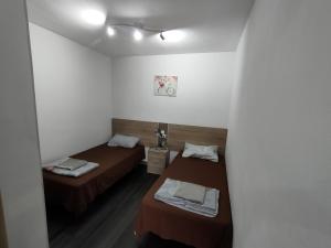 a room with two beds and a mirror at Lorena in Salou