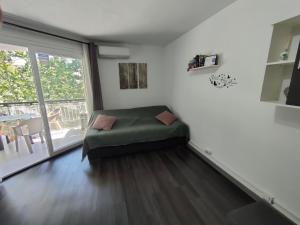 a room with a green ottoman in a room with a window at Lorena in Salou