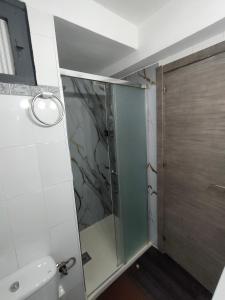 a bathroom with a shower and a glass door at Lorena in Salou +7 photos