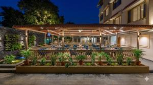 an exterior view of a hotel with a patio with plants at Mountview Resort in Lonavala