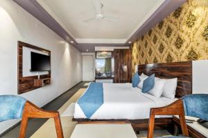 a hotel room with a bed and a tv at Mountview Resort in Lonavala