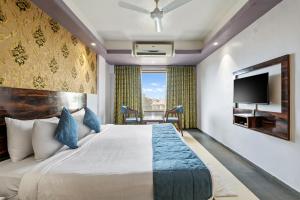 a hotel room with a bed and a tv at Mountview Resort in Lonavala