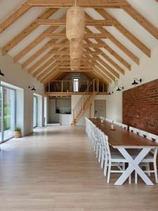 a large dining room with a long table and a brick wall at Złota#208 in Złota +50 photos
