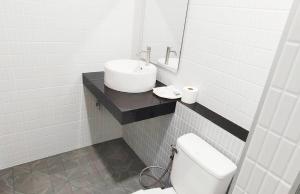 a white bathroom with a sink and a toilet at DD Villa in Pathiu +29 photos