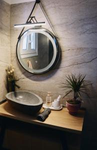 a bathroom with a sink and a mirror on a counter at Mountain Aura - Stylish Escape in Kamarítsa +49 photos