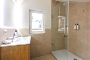 a bathroom with a sink and a shower at Le Catherine by Sweett in Brussels