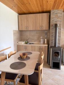 a kitchen with a wooden table and a stove at Holiday Home Apartman Aco in Žabljak
