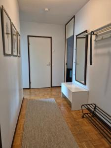 a room with a white table and a mirror at Apartment with private sauna in Loimaa