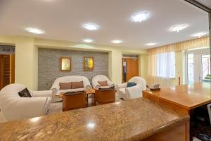 a living room with chairs and a table in a room at Hotel Empire Europe in Prievidza