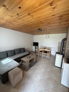 a living room with a couch and a table at Holiday Home Apartman Aco in Žabljak