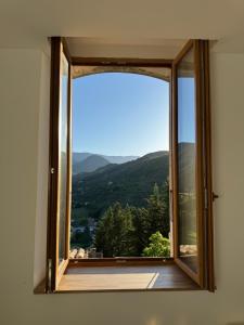an open window with a view of a mountain at Portail Sainte Marie in Montbrun-les-Bains